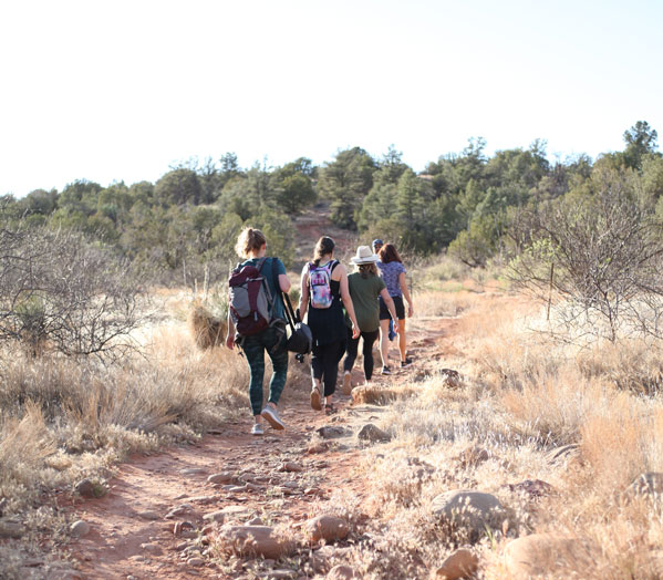 Family and crew hiking on trail.