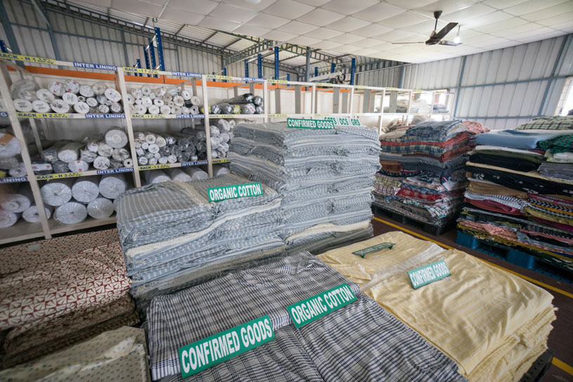 Stacks of organic and sustainable fabrics in factory.